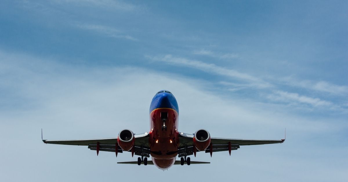 Red and blue airplane against a blue sky