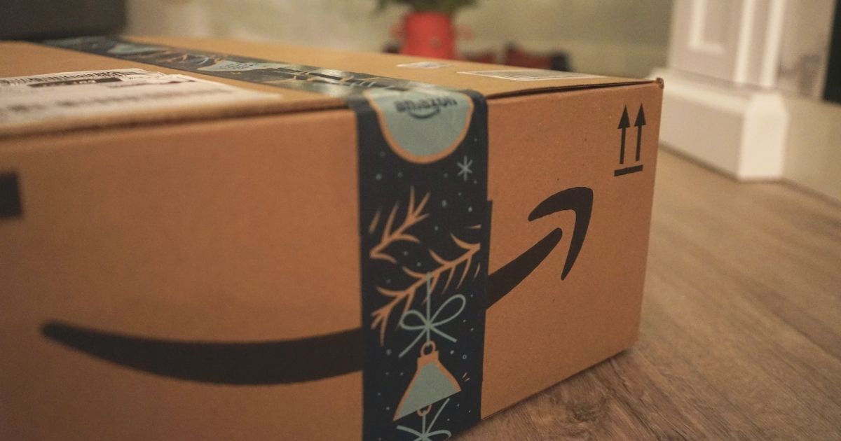 Brown and black amazon box under a Christmas tree