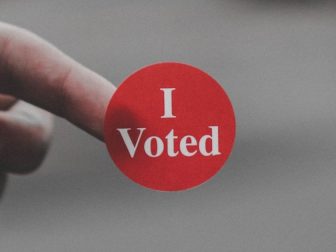 The above stock photo shows a sticker that says, "I Voted."