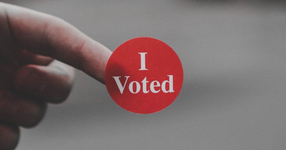 The above stock photo shows a sticker that says, "I Voted."