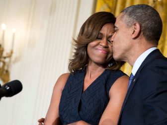 President Barack Obama kisses First Lady Michelle Obama during her remarks at an Affordable Care Act reception in the East Room of the White House, May 1, 2014. (Official White House Photo by Pete Souza)