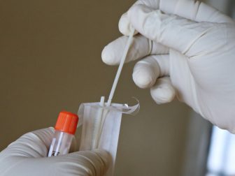 a laboratory expert takes a covid-19 swab test