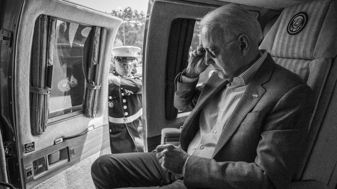 A U.S. Marine opens the door as President Joe Biden prepares to disembark Marine One, Saturday, July 3, 2021, at Antrim County Airport in Bellaire, Michigan.