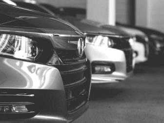 Black and white photo of a row of Honda Accords at a dealership in Fairfax Virginia with emphasis on the headlights.