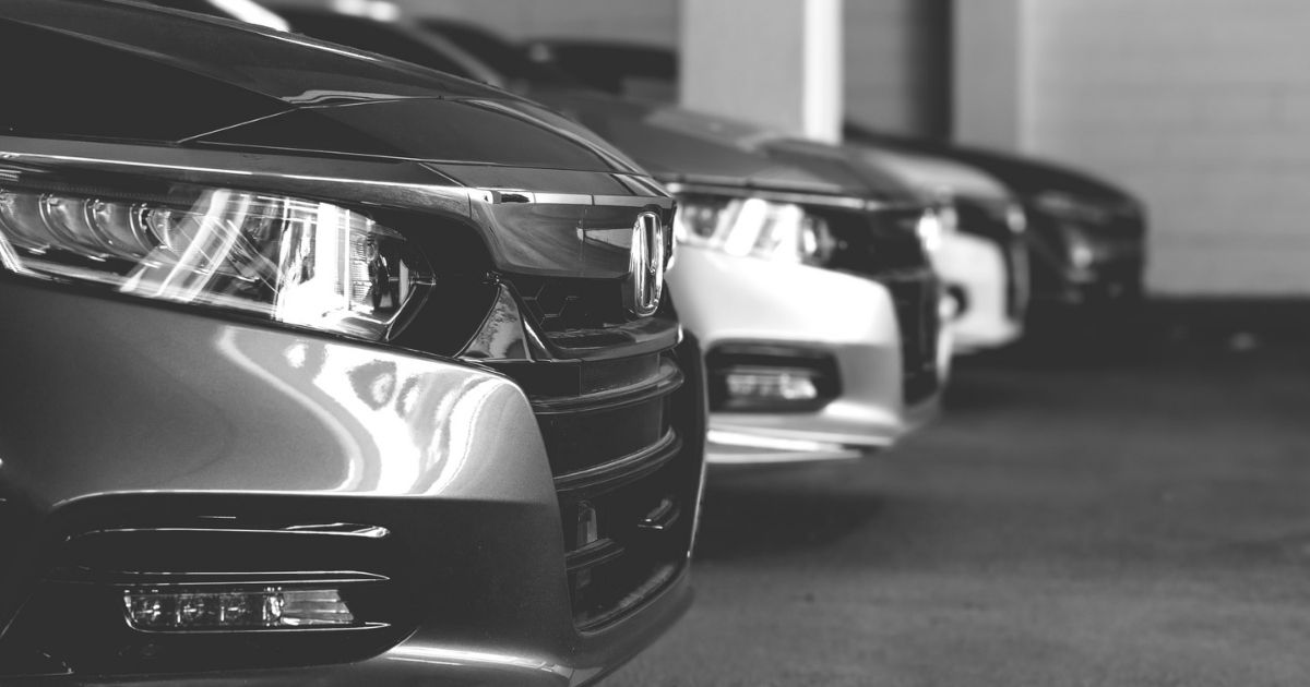 Black and white photo of a row of Honda Accords at a dealership in Fairfax Virginia with emphasis on the headlights.