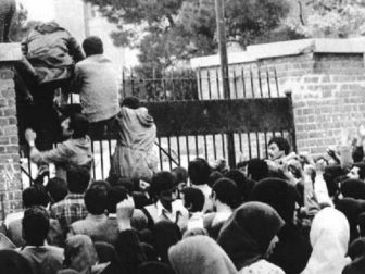 Iranian students climb up the U.S. embassy gates in Tehran on Nov. 4, 1979.