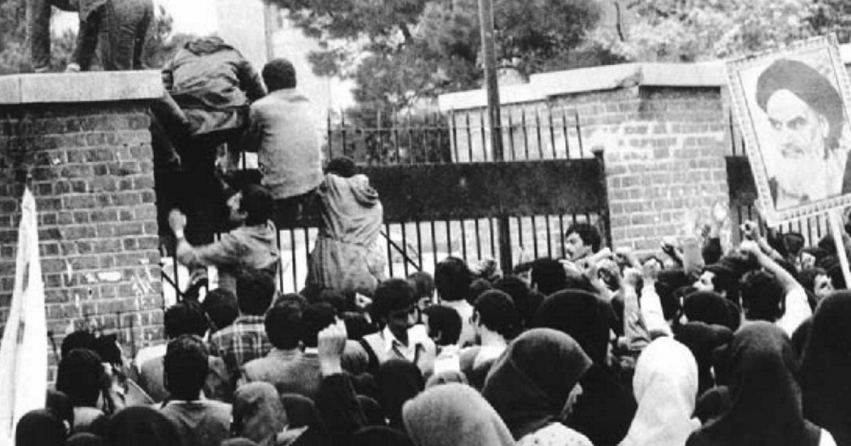Iranian students climb up the U.S. embassy gates in Tehran on Nov. 4, 1979.