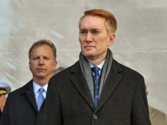 Sen. James Lankford (R-OK) stands for the parading of the colors during the commissioning ceremony of littoral combat ship USS Tulsa (LCS 16).