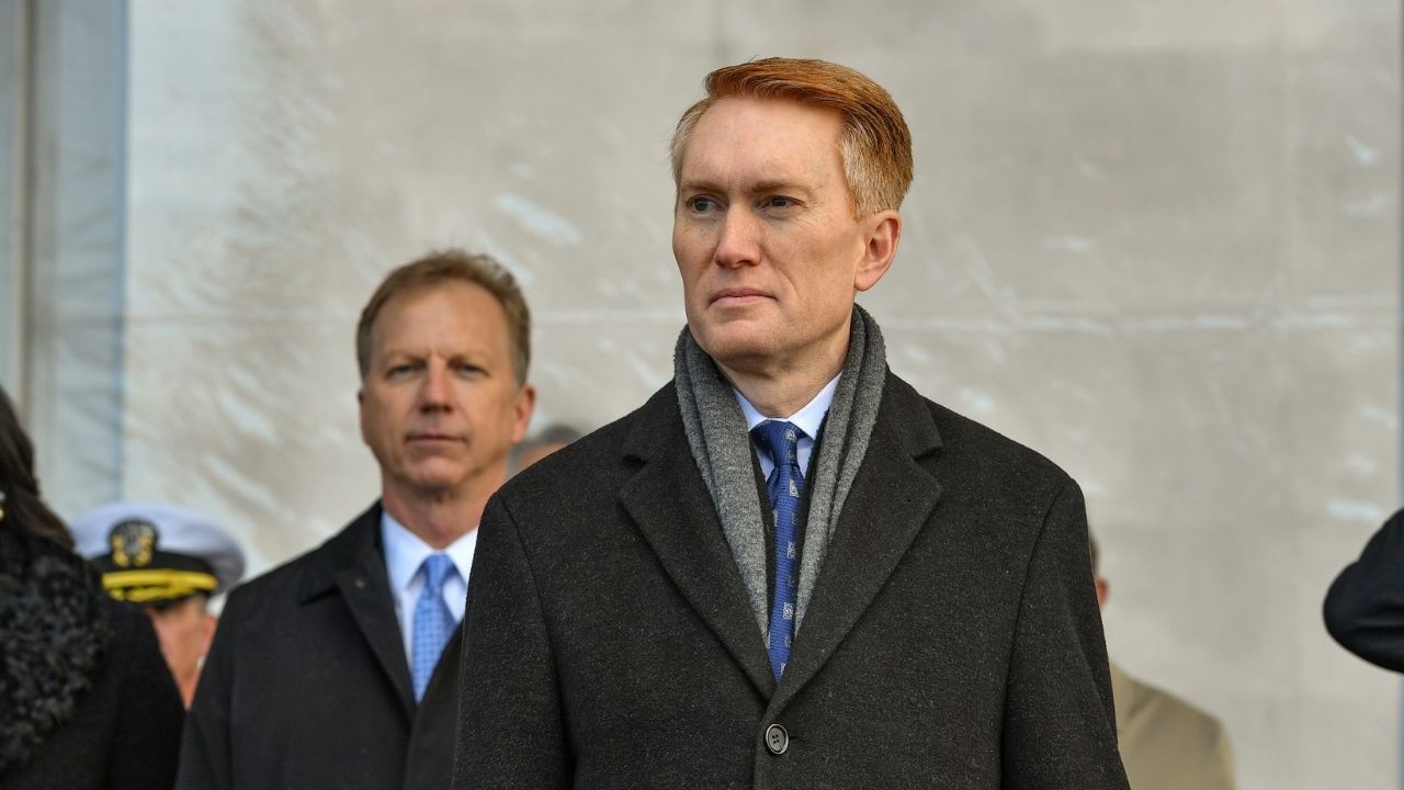 Sen. James Lankford (R-OK) stands for the parading of the colors during the commissioning ceremony of littoral combat ship USS Tulsa (LCS 16).