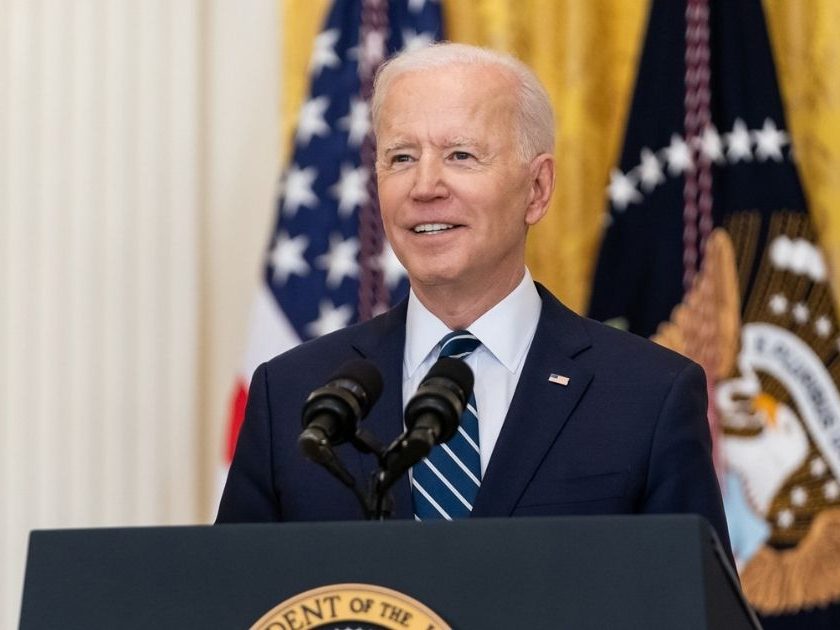 President Joe Biden speaks at the podium.