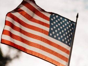 Crop unrecognizable patriot celebrating Memorial Day showing American flag