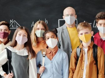 Students and teacher wearing masks