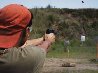 Man in orange hat practicing shooting