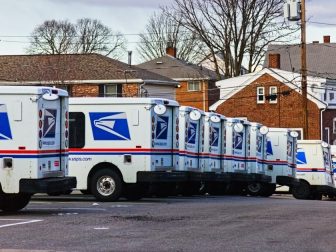United States Postal Service mail vans lined up at the Waltham, Massachusetts mail handling facility this winter