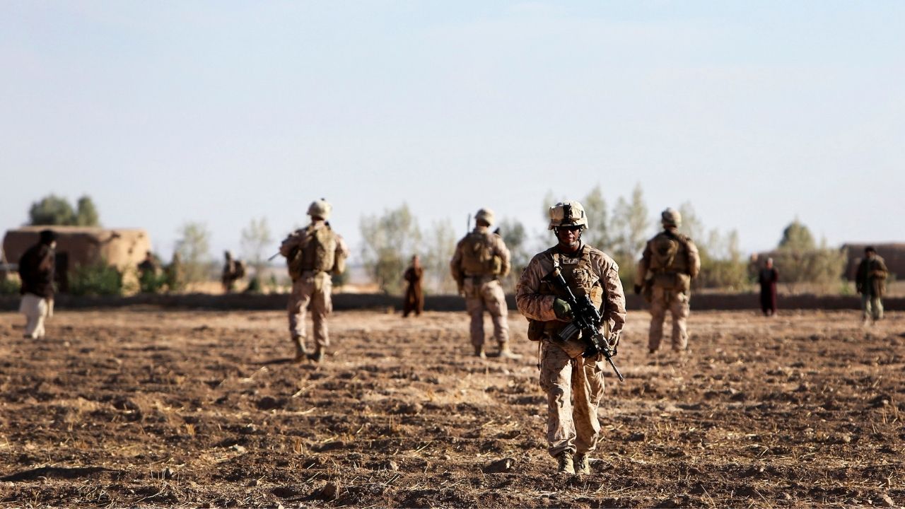 Marines with Charlie Company, 1st Battalion, 9th Marine Regiment, cross a field during an operation in Helmand province, Afghanistan, Nov. 10, 2013. The operation was conducted to disrupt enemy activity in the area.