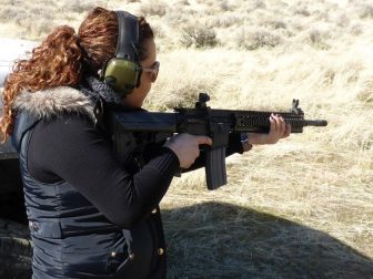 A woman holds an AR-15 rifle during shooting practice on Feb. 12, 2017.