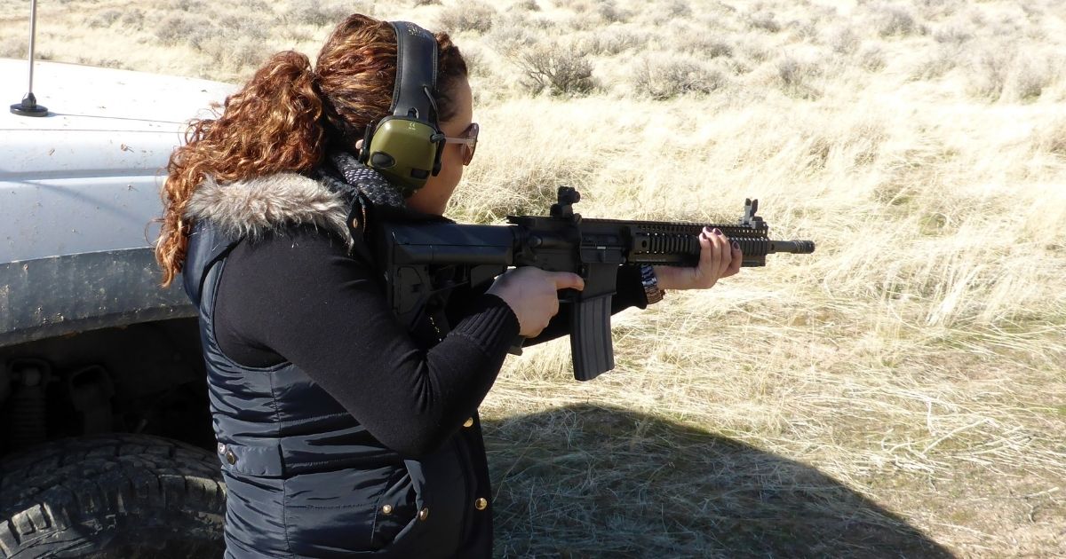 A woman holds an AR-15 rifle during shooting practice on Feb. 12, 2017.