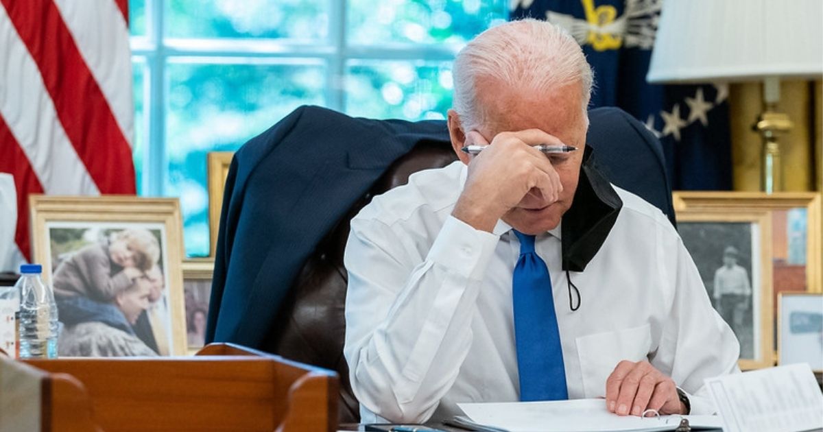 President Joe Biden reviews remarks in the Oval Office of the White House.