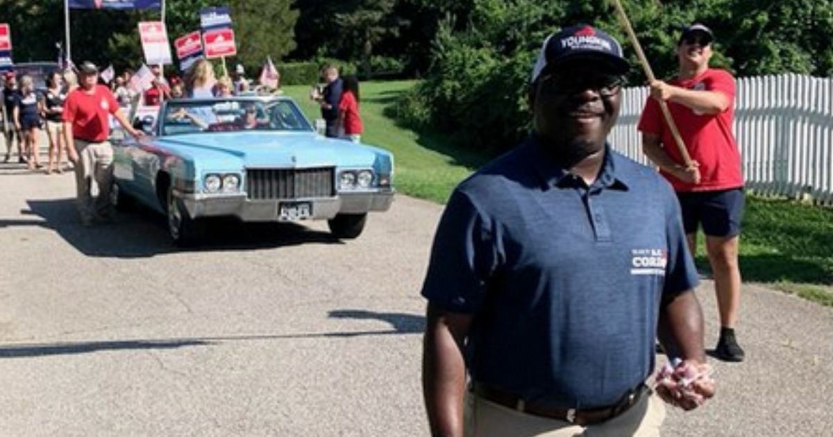 A.C. Cordoza, left, a Republican delegate challenger in Virginia's 91st District, enjoys a Fourth of July parade in Yorktown with several other candidates on the campaign trail.