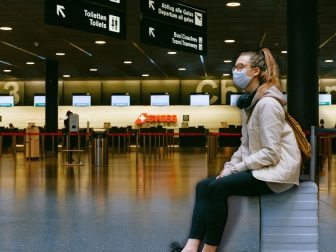 Woman Sitting on Luggage