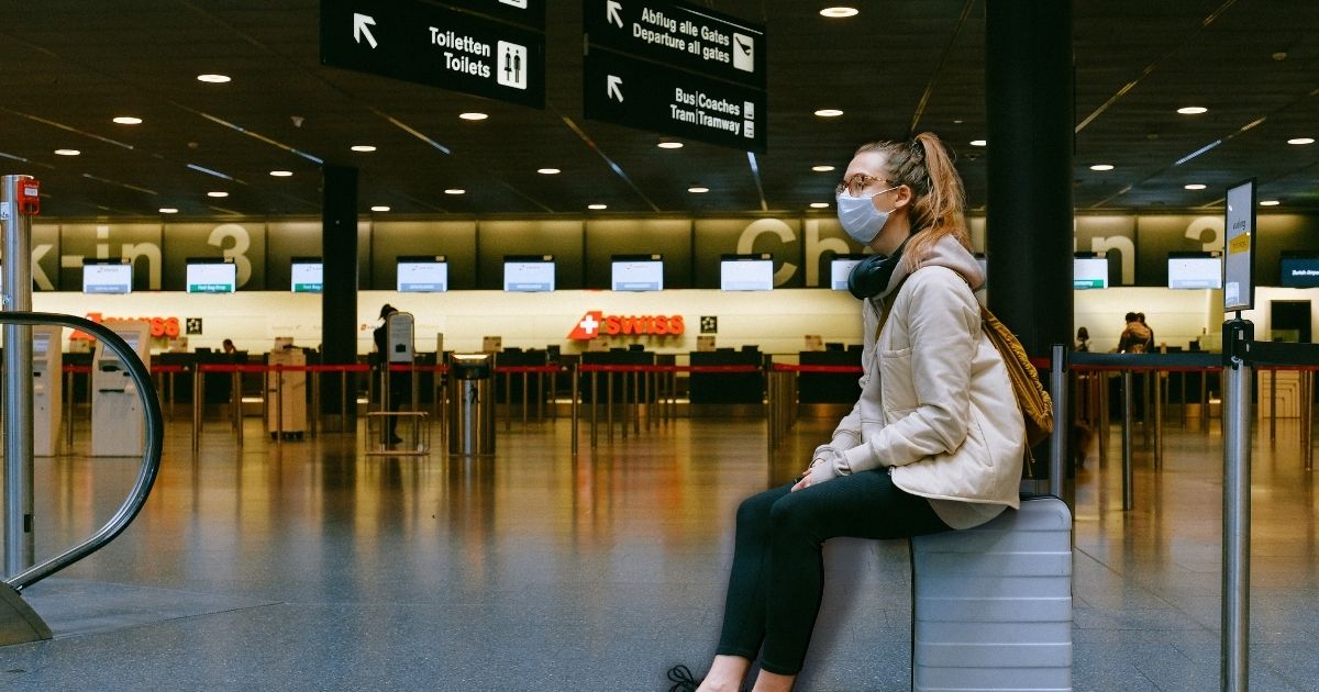 Woman Sitting on Luggage