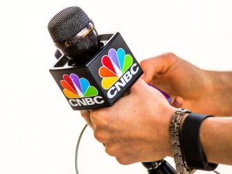 CNBC reporter holding microphone.