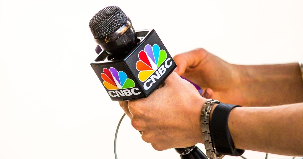 CNBC reporter holding microphone.