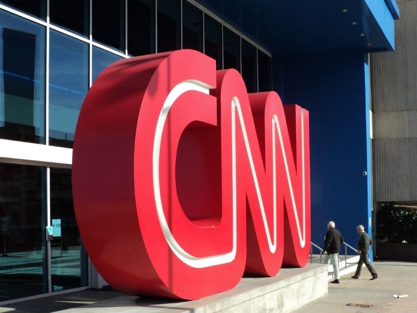 Two men walking into CNN Center.