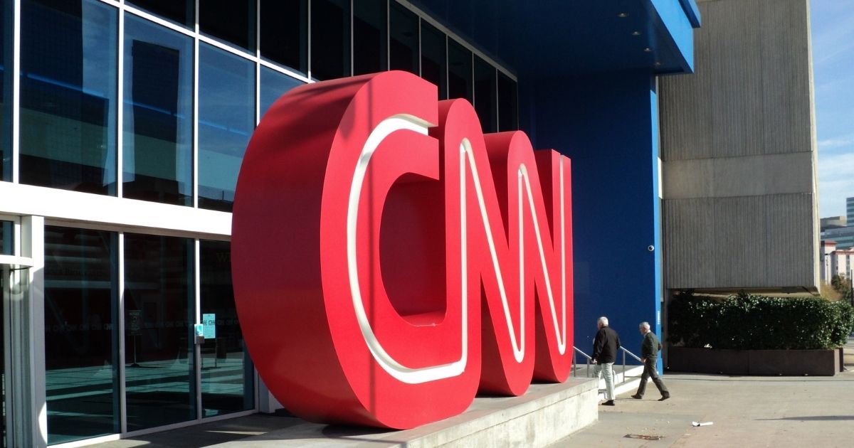 Two men walking into CNN Center.