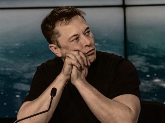 SpaceX and Tesla CEO Elon Musk listens at a meeting.