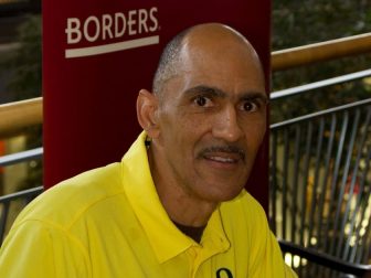 Tony Dungy signing books. (John Ramspott / Flickr)