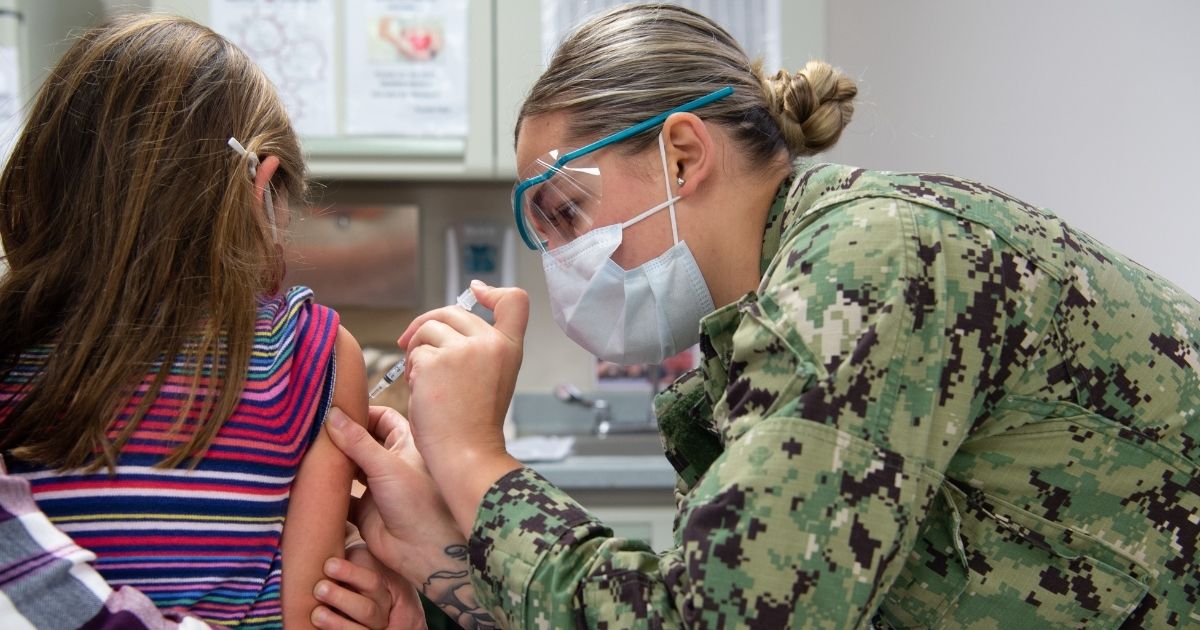 A young girl receives the COVID-19 vaccine at Navy Medical Center Portsmouth in November 2021.
