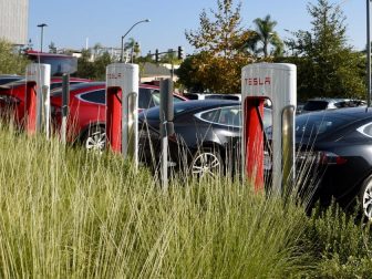 Tesla cars charging in a parking lot