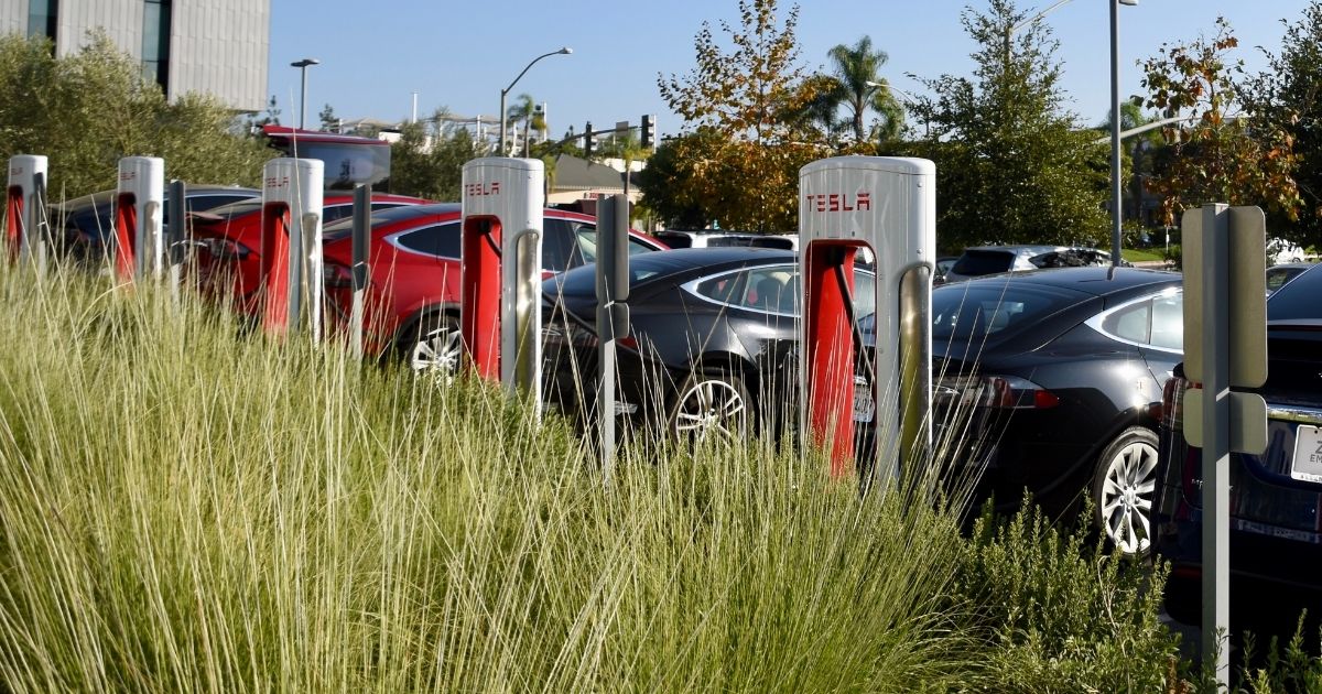 Tesla cars charging in a parking lot