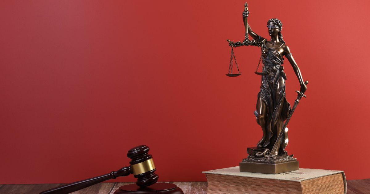 A statue of Lady Justice and a judge gavel are seen in this photo.