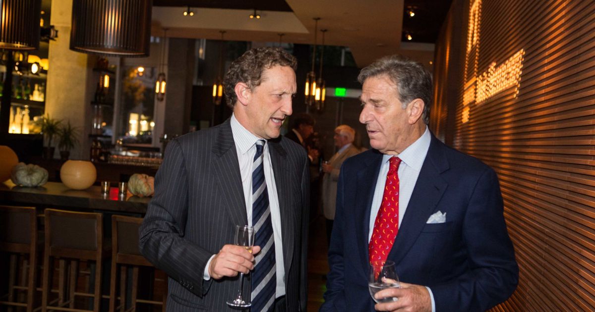 Larry Baer (left) and Paul Pelosi, Sr. (right) holding glasses.