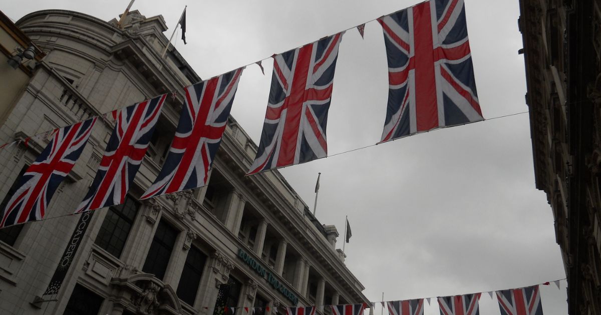 Union Jack flags are seen over Coventry Street.