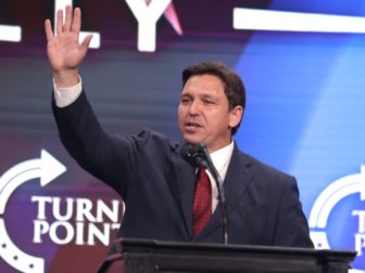 Governor Ron DeSantis speaking with attendees at a "Unite & Win Rally" at Arizona Financial Theatre in Phoenix, Arizona.