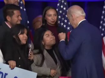 President Joe Biden puts his fists to a young woman's face after a speech Tuesday in Washington.