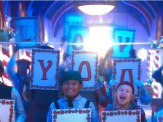 Signs spelling out "We Love You Satan" are seen in Disney's "The Santa Clauses."