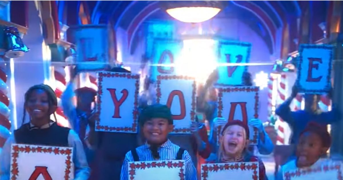 Signs spelling out "We Love You Satan" are seen in Disney's "The Santa Clauses."