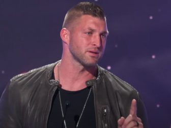 Tim Tebow speaks on stage after receiving the Sports Impact Award at the K-LOVE Fan Awards in Nashville, Tennessee, on May 29.