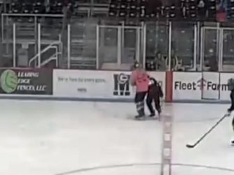 A male hockey player slams a female hockey player during a "transgender" game in Middleton, Wisconsin.