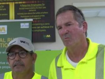 Two waste management workers saved an elderly man after he became trapped under a golf cart.