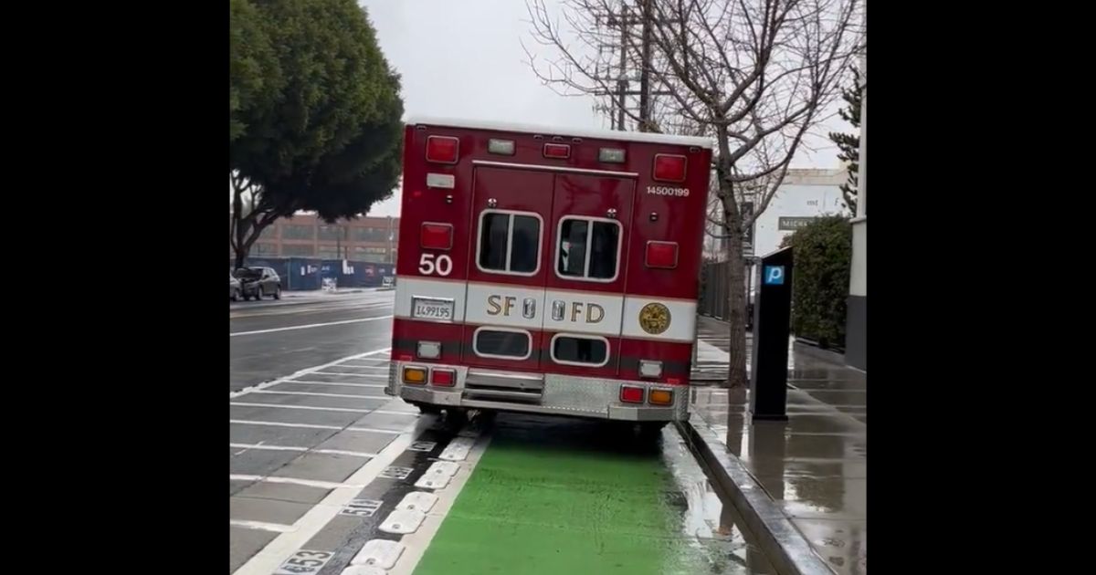 An ambulance sits in the bike lane in San Francisco.