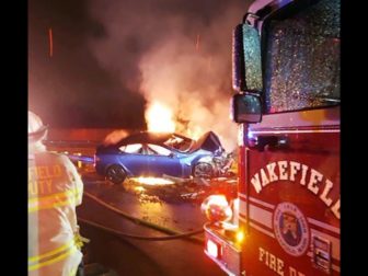 Firefighters work to put out an electric vehicle fire in Wakefield, Massachusetts, on Thursday.