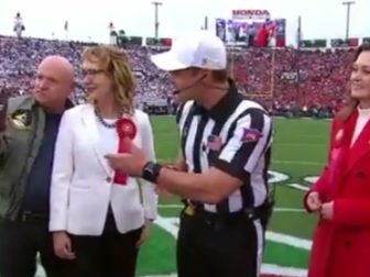 Sen. Mark Kelly of Arizona videos the coin toss of Monday's Rose Bowl.