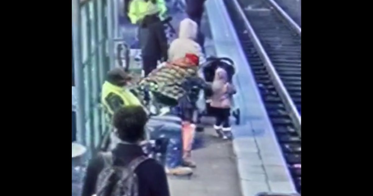 This video screen shot shows a person shoving a child onto train tracks in Portland.