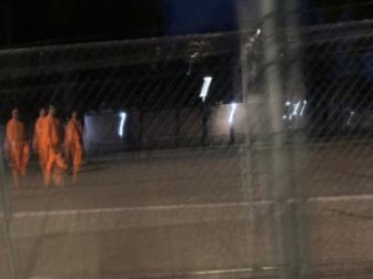 This screen shot reportedly shows orange-clad prison labor setting up Katie Hobbs' inauguration.