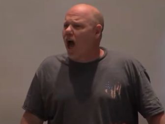 An angry parent shouts at members of the Loudoun County, Virginia, school board during its meeting Feb. 14.